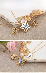 Detail of blue zircon sunflower pendant necklace and stud earrings in fine steel
