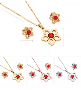 Detail showing the flower pendant and earrings set with red crystal in gold plating