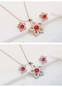 Detail of flower-shaped ruby crystal necklace and earring sets in rose gold and silver