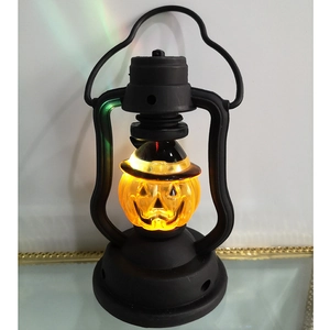Halloween LED pumpkin lantern detail close up showing glowing carved jack o lantern face inside.