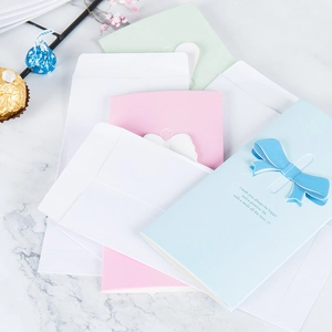 Creative 3D butterfly and heart greeting cards set with macaron envelopes on marble