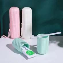 Portable travel toothbrush capsule case in pink, white, and mint green with lanyards