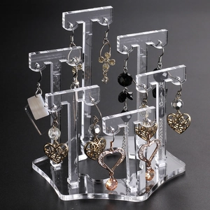 Plum-shaped acrylic earring display stand with multiple pillars on a hexagonal base