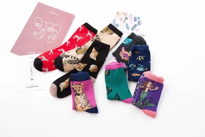 Flat lay detail of seven mid-calf cotton socks with animal and nature inspired patterns