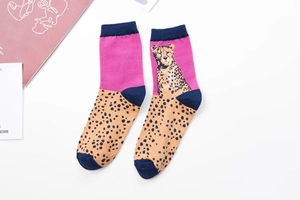Detailed close-up of pink and leopard print cotton crew socks with dark blue toe accents