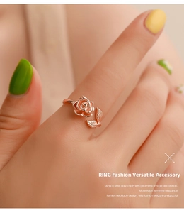 Detailed view of vintage rose gold adjustable ring with 3D flower and leaf worn on hand