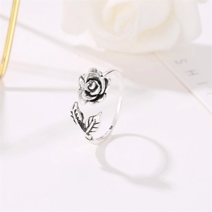 Macro view of vintage silver rose ring showing detailed petals and antique finish texture
