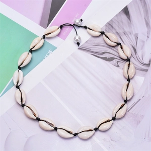 Detail of adjustable natural white shell choker with black cord on color swatches