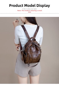 Rear view of a model wearing the small vintage brown leather anti-theft backpack