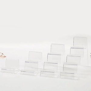 Macro view of transparent acrylic tiered display stand with multi-layer structure for wallets