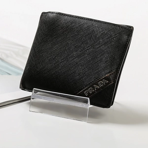 Clear acrylic display stand showing a Saffiano leather wallet in a detailed product view