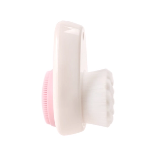 Dual-sided silicone facial cleansing brush with pink soft bristles and manual white handle