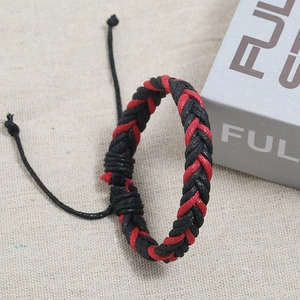 Detailed view of handmade woven red and black rope bracelet with adjustable cord closure
