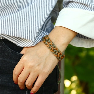 Handmade woven couple bracelet with olive green and brown wax cords in a minimalist boho style