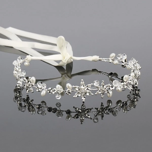 Elegant silver bridal headband with pearls and rhinestones on a white ribbon