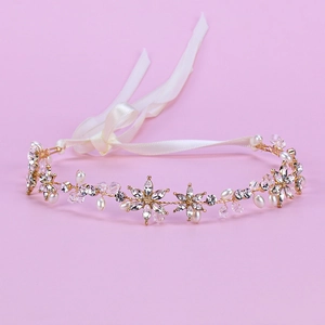 Detail of handmade gold flower hairband with white crystal pearls and adjustable ribbon