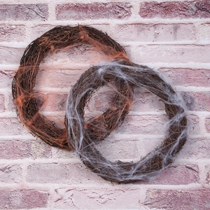 Rustic vine wreaths with white and orange artificial spider webs for Halloween decor