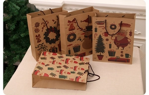 Christmas kraft paper gift bags with Santa and snowman prints displayed by a cozy fireplace