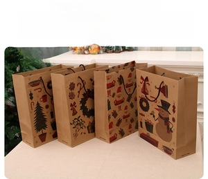 Set of four Christmas kraft paper gift bags with festive tree and snowman patterns