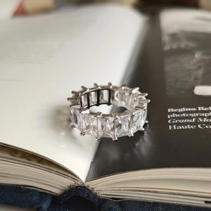 Close-up of S925 sterling silver ring with square-cut cubic zirconia in a book gap