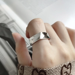 Minimalist 925 sterling silver geometric faceted ring shown on a model hand