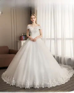 Exquisite close-up of lace floral details and sequins on a white off-shoulder bridal gown