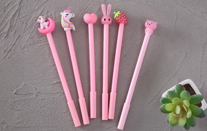 Close-up of 6 pink pens with unique cartoon toppers like unicorns and hearts