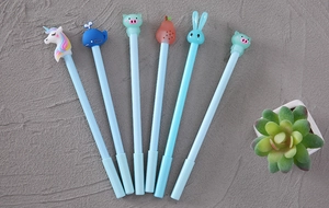 Detailed fan-shaped arrangement of six light blue cartoon gel pens with cute silicone toppers