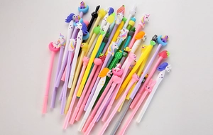 Close-up of colorful cartoon gel pens featuring 3D silicone animal and fruit toppers