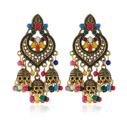 Close-up of vintage Jhumka earrings with colorful enamel and beaded tassel bells