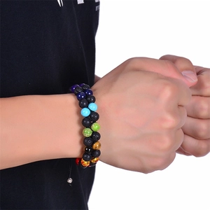 Detail of a double-layered chakra bracelet with volcanic lava stones on a wrist