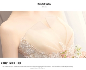 Close-up of champagne lace embroidery and delicate beadwork on a strapless bridal gown