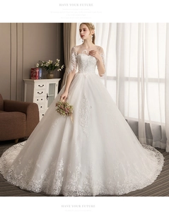 Detailed view of white bridal gown with intricate European lace embroidery and sequins