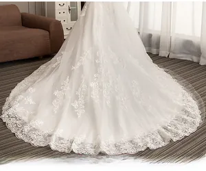 Detailed macro view of the intricate lace embroidery on the white bridal wedding train
