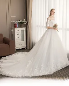 Detail view of the intricate lace embroidery on the elegant white bridal gown train
