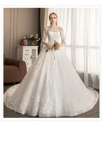 Detail of elegant white wedding dress with lace embroidery and sheer middle sleeves