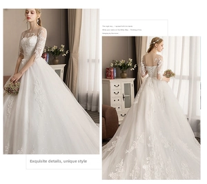 Detail of white ball gown wedding dress with lace embroidery and lace-up back design