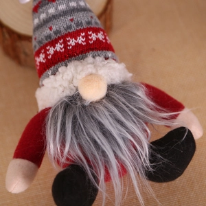 Plush Christmas Gnome doll with knitted hat and faux fur beard on rustic burlap background