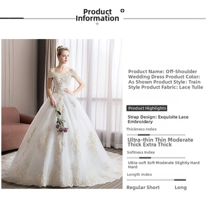 Exquisite white lace embroidery detail on the off-the-shoulder wedding gown train