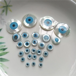 Macro shot of natural white mother of pearl evil eye shell beads in various sizes