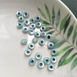 Macro shot of natural white shell evil eye loose beads for jewelry making