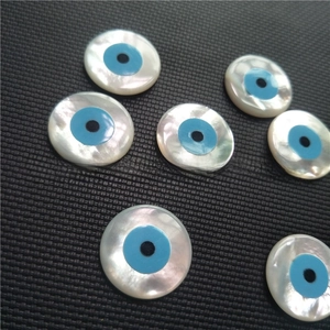 Macro shot of natural white mother of pearl evil eye beads for DIY jewelry making