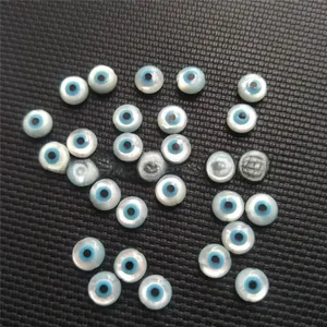 Macro shot of natural white mother of pearl evil eye beads for DIY jewelry making