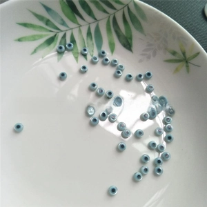 Macro shot of light blue shell evil eye beads for DIY handmade jewelry making