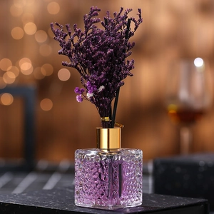 Lavender reed diffuser set with purple flowers in square glass bottle with gold collar