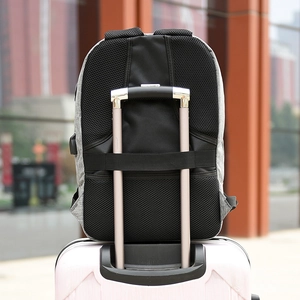 Gray anti-theft laptop backpack with luggage strap mounted on a trolley case handle