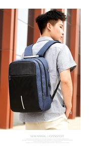 Close-up of blue and black business backpack showing side USB port and earphone jack