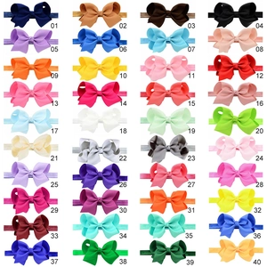 Grid layout showing forty assorted colors of handmade elastic baby bow headbands