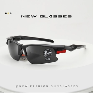 Detail of ergonomic black sports sunglasses with red side accents and polarized lenses