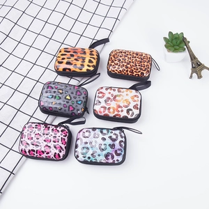 Detail view of 6 colorful leopard print mini hardshell coin purses with zippers